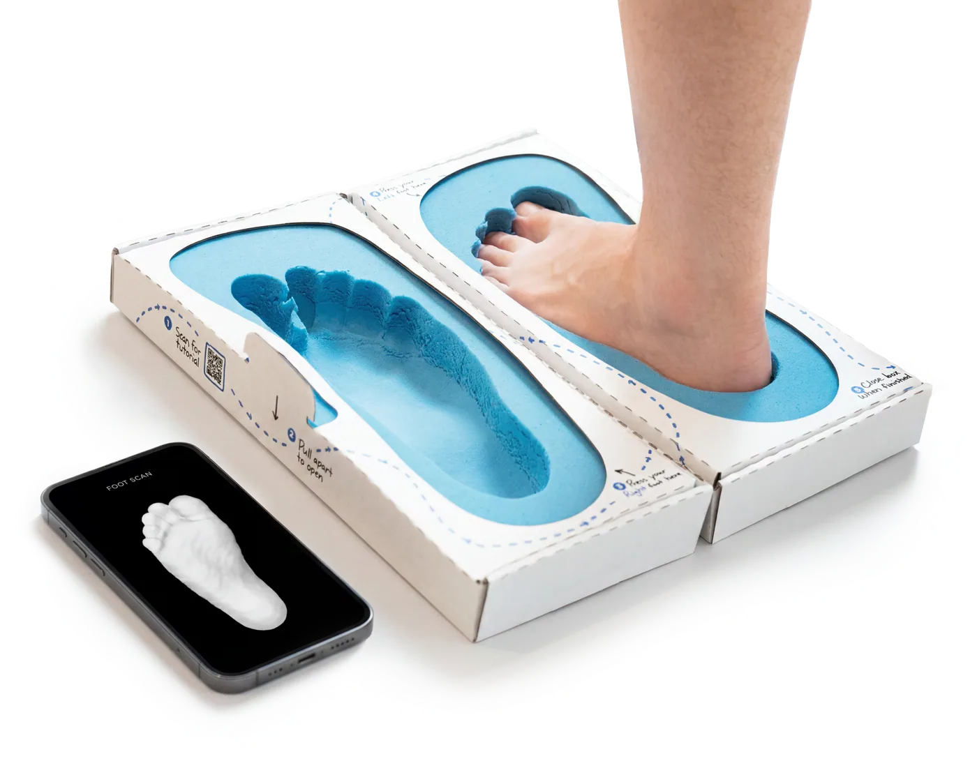 Foot pressed into the foam impression box next to an iPhone foot scan