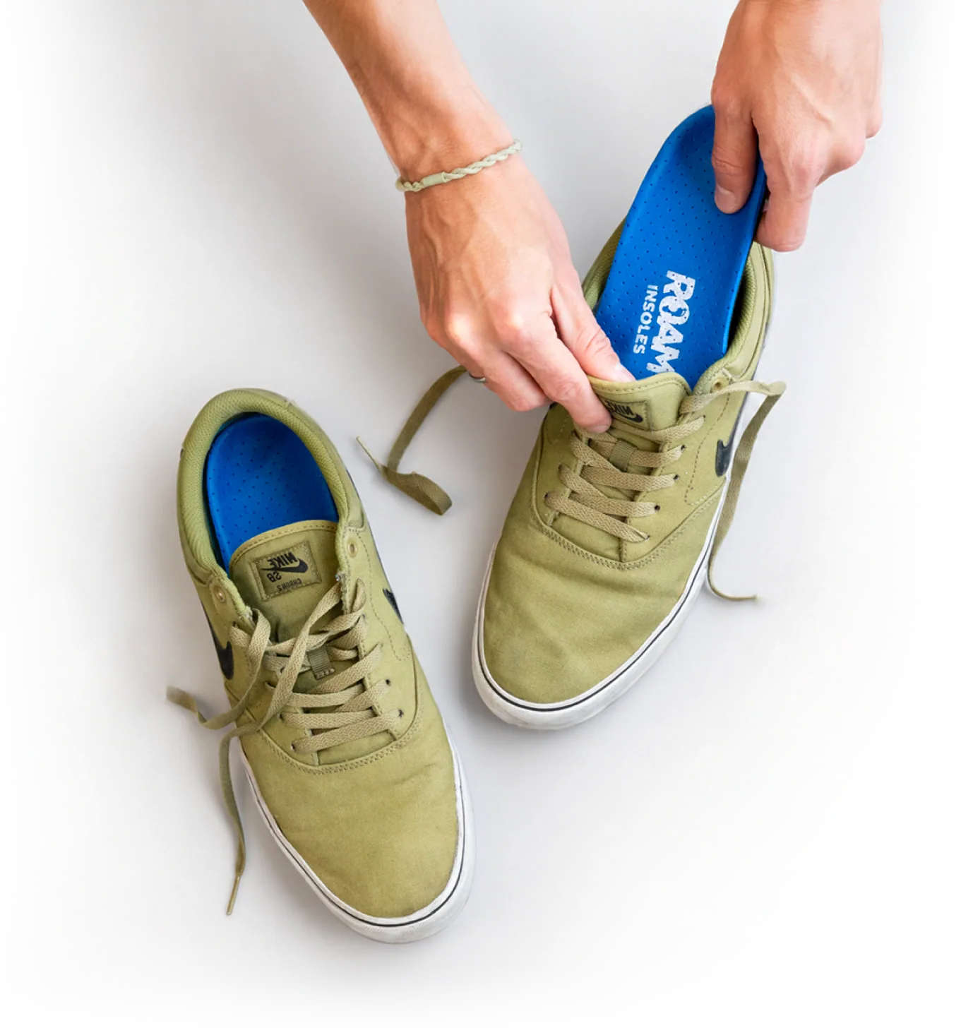 Roam insole being placed into a shoe